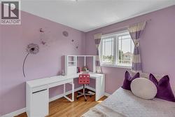 Hardwood flooring, double-paned window, built-in desk with shelving, and overhead lighting - 