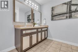 Dual vanity with integrated sinks, framed mirrors, and a multi-light fixture - 