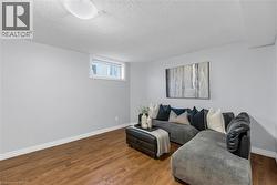 Wood-finish flooring with light gray walls, white trim, and a flush-mount ceiling light - 