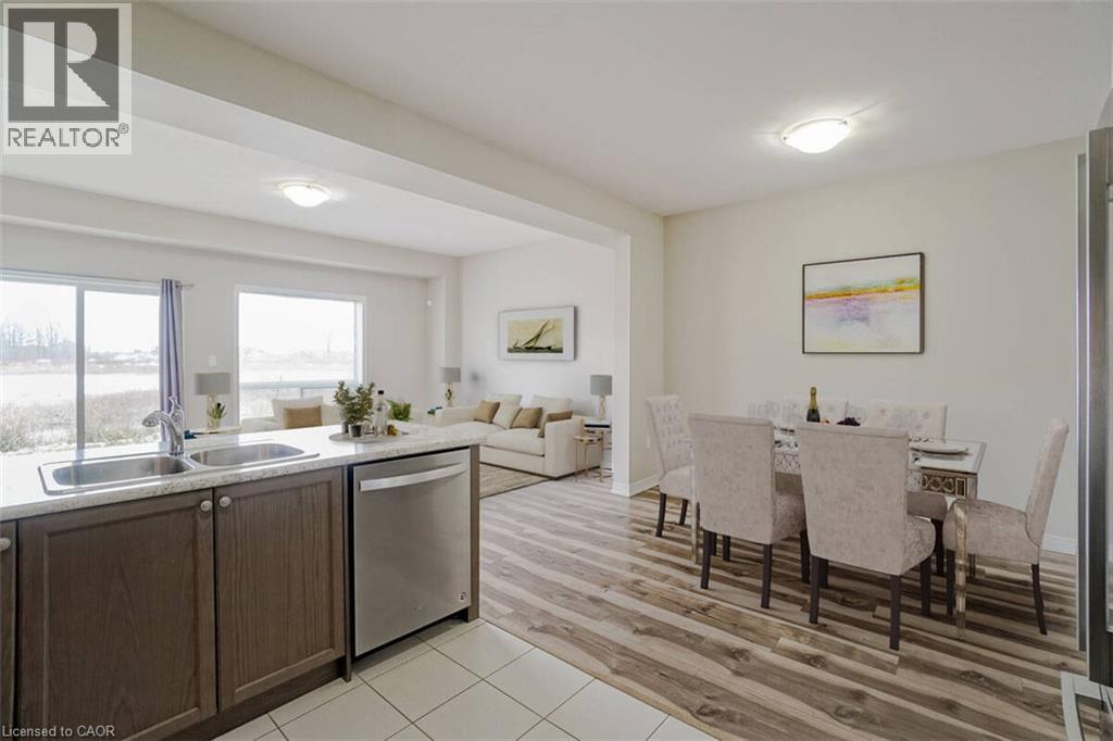 Open-concept living space with wood-finish flooring, white walls, and recessed lighting - 70 Bradbury Road, Hamilton, ON - Indoor Photo Showing Kitchen With Double Sink