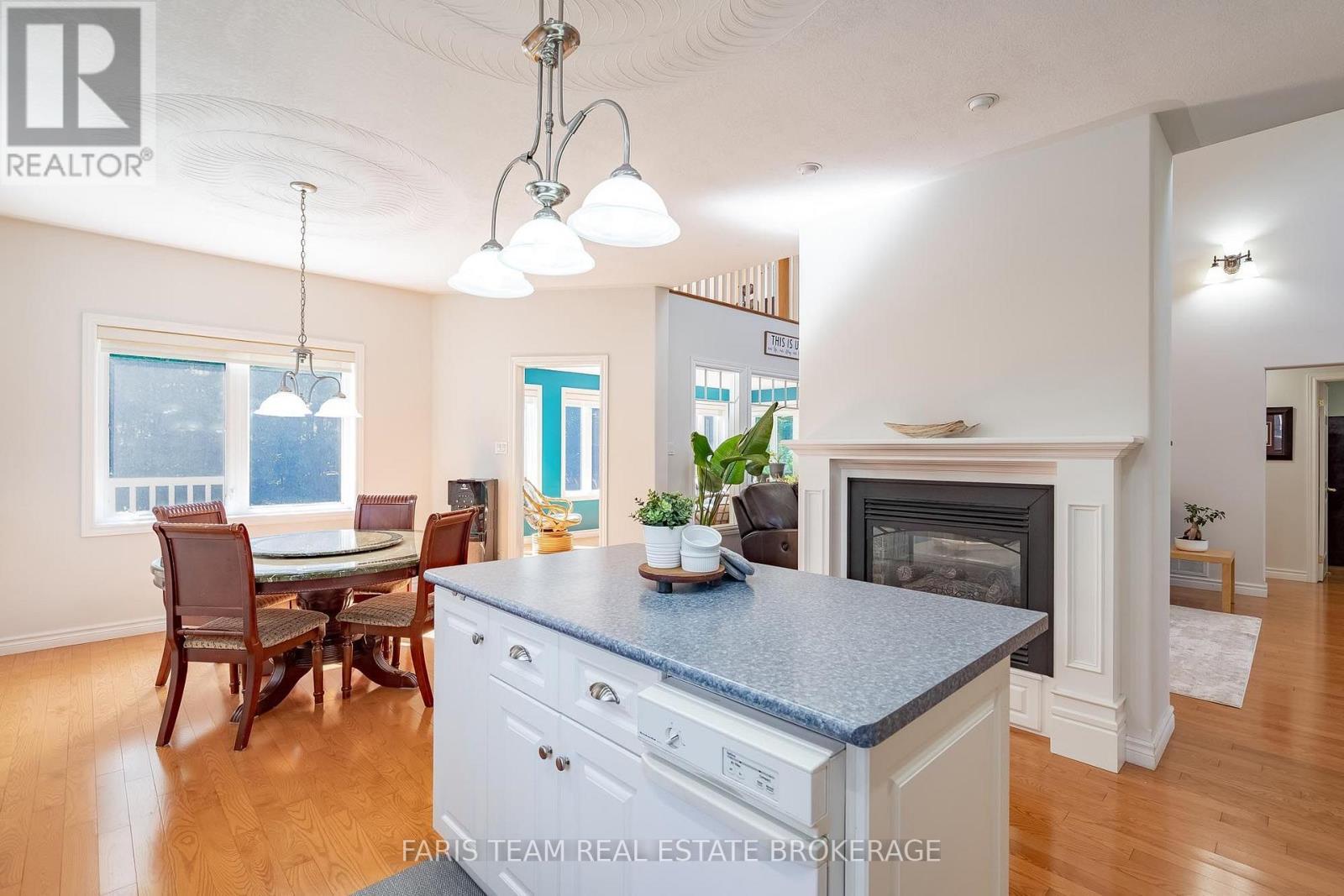 91 Maryjane Road, Tiny, ON - Indoor Photo Showing Dining Room With Fireplace