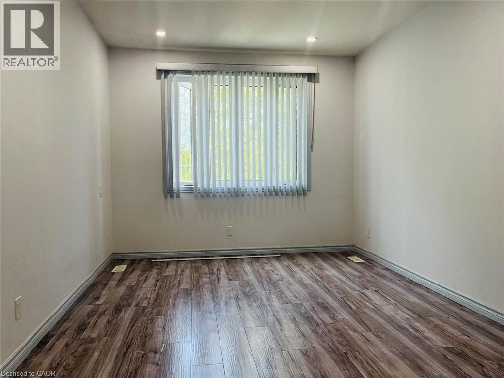 Wall-to-wall wood-finish flooring - 83 Keewatin Avenue, Kitchener, ON - Indoor Photo Showing Other Room