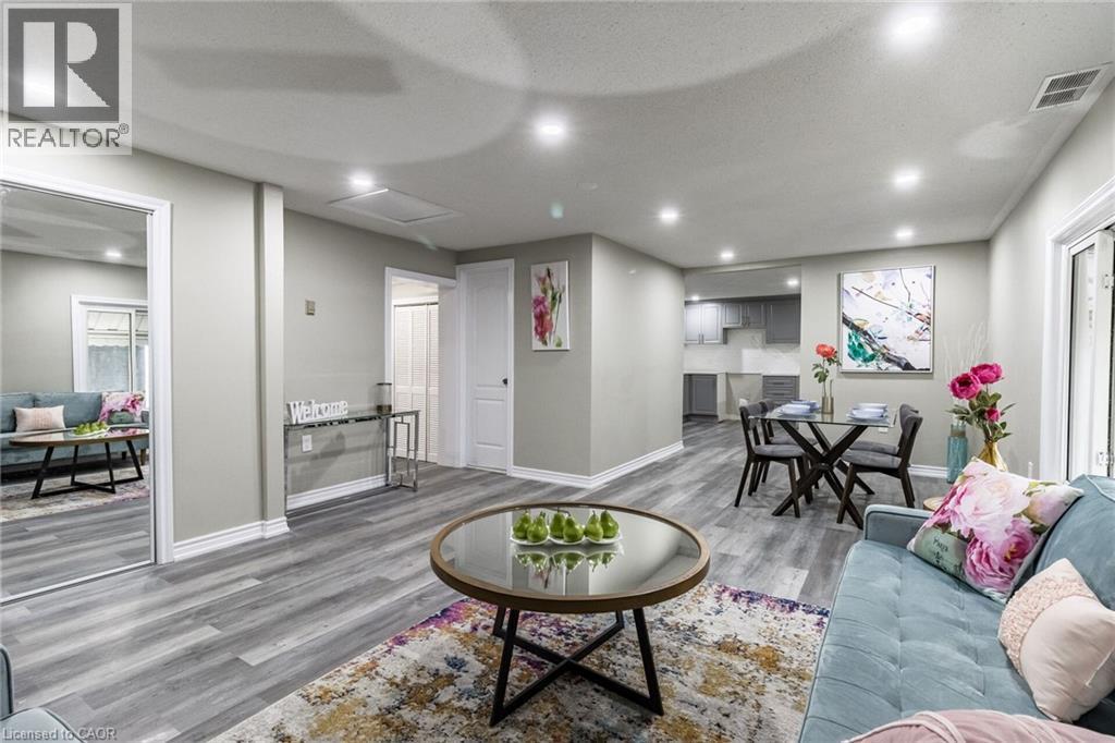 Open-concept living area featuring recessed lighting, wood-finish flooring, and white trim - 15 Spiers Crescent, Cambridge, ON - Indoor