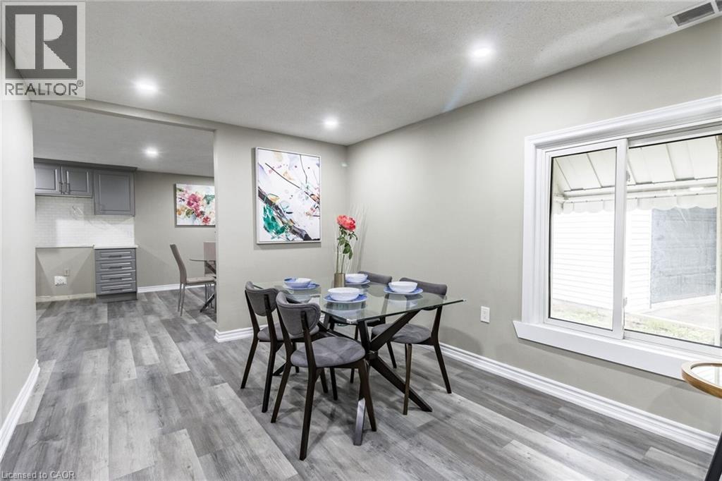 Recessed ceiling lighting, wood-finish flooring, sliding window, gray shaker cabinetry, and a white tile backsplash - 15 Spiers Crescent, Cambridge, ON - Indoor
