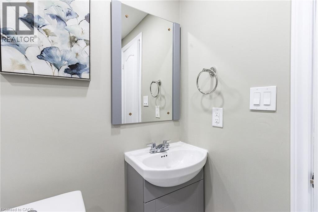 Pedestal sink with integrated cabinet, chrome faucet, and mirrored medicine cabinet - 15 Spiers Crescent, Cambridge, ON - Indoor Photo Showing Bathroom