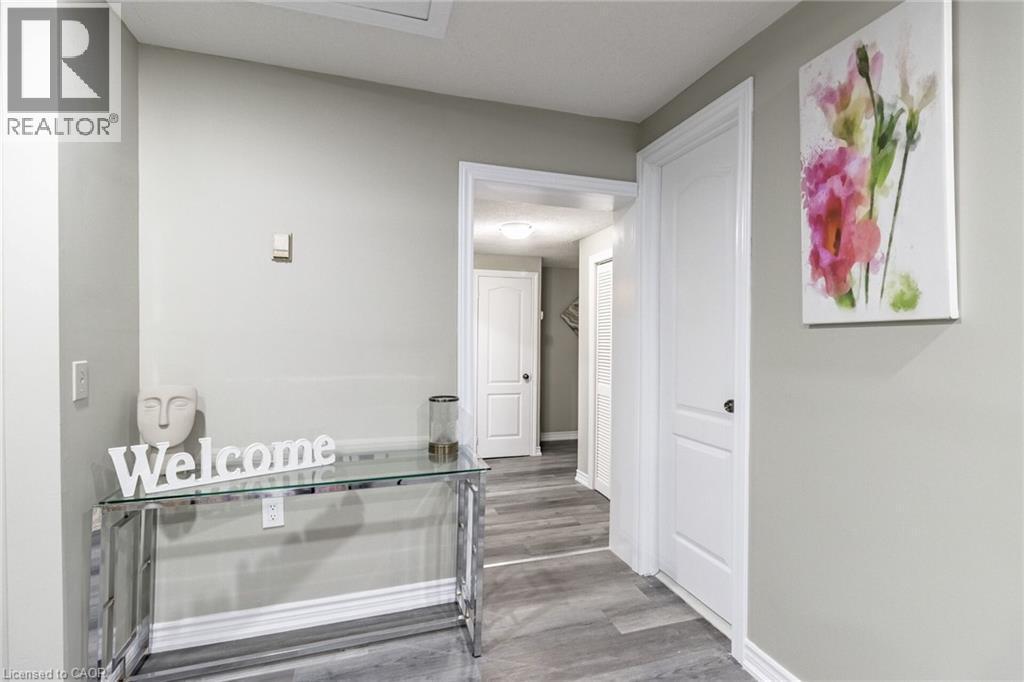 Wood-finish flooring throughout, white interior doors, and crisp white trimwork - 15 Spiers Crescent, Cambridge, ON - Indoor