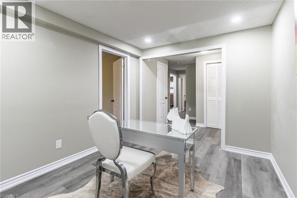 Recessed ceiling lighting, light gray wall paint, wood-finish flooring, white trim, and white louvered closet doors - 15 Spiers Crescent, Cambridge, ON - Indoor