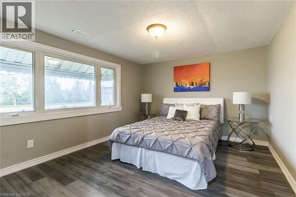 Large window with white trim, wood-finish flooring, and recessed ceiling lighting - 15 Spiers Crescent, Cambridge, ON - Indoor Photo Showing Bedroom