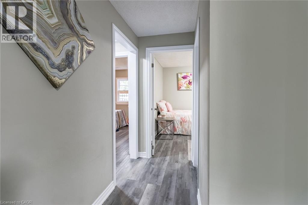 Hallway featuring wood-finish flooring, light-toned walls, and white trim - 15 Spiers Crescent, Cambridge, ON - Indoor Photo Showing Other Room