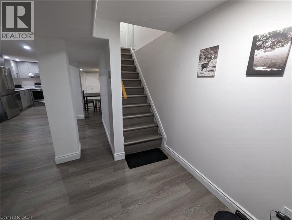 Wood-finish flooring throughout, with a neutral wall color and recessed lighting - 510 Oakridge Place, Waterloo, ON - Indoor Photo Showing Other Room