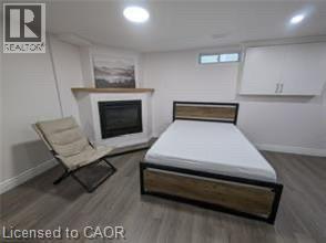 Finished basement bedroom featuring wood-finish flooring, recessed ceiling lighting, and ample built-in storage cabinetry - 510 Oakridge Place, Waterloo, ON - Indoor