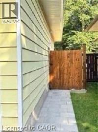 Siding exterior, paved walkway, wooden fence, and manicured lawn - 510 Oakridge Place, Waterloo, ON - Outdoor
