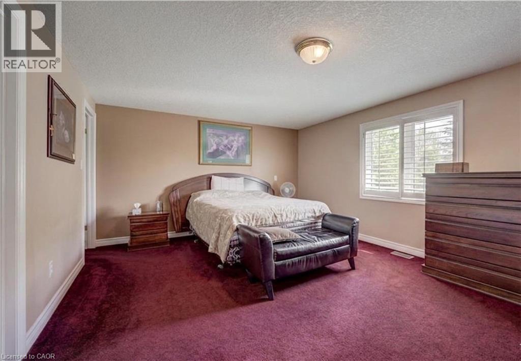 Spacious bedroom featuring deep pile carpeting and neutral tone walls - 599 Coldstream Drive, Waterloo, ON - Indoor Photo Showing Bedroom