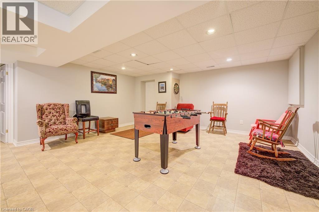 Finished basement featuring light-toned square tile flooring, recessed lighting, and painted walls - 599 Coldstream Drive, Waterloo, ON - Indoor