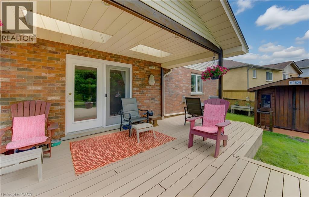 Covered patio deck featuring a brick exterior wall and dual skylights - 599 Coldstream Drive, Waterloo, ON - Outdoor With Deck Patio Veranda With Exterior