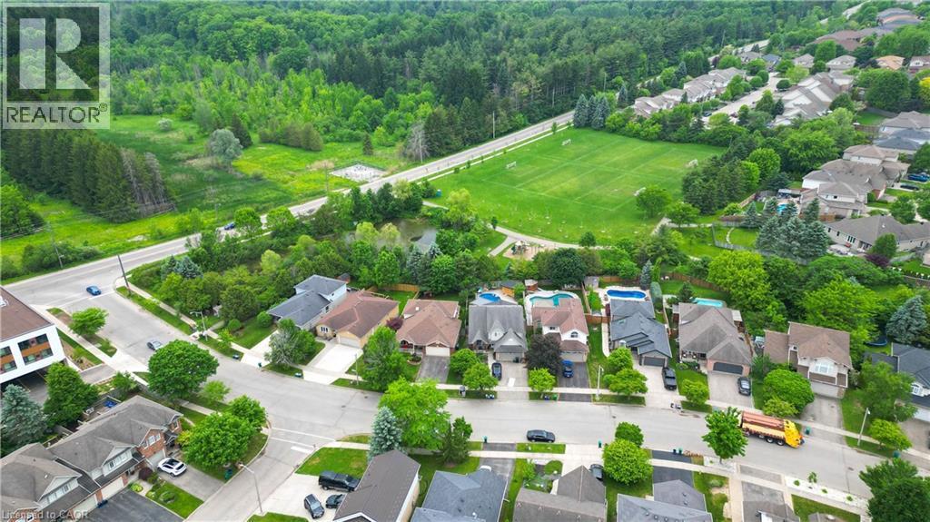 Aerial perspective showcasing a residential area with mature trees and green spaces - 599 Coldstream Drive, Waterloo, ON - Outdoor With View