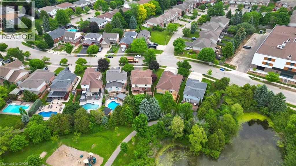 Aerial view of a residential neighborhood with multiple properties featuring private swimming pools - 599 Coldstream Drive, Waterloo, ON - Outdoor With View