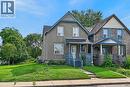Two-story residence with a covered front porch featuring a lattice railing, a peaked gable roof, and a paved walkway leading to the entrance - 230 Picton Street E, Hamilton, ON  - Outdoor With Facade 