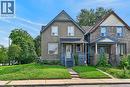 Exterior featuring a gabled roofline, light-colored stucco finish, covered front porch, and a dedicated walkway - 230 Picton Street E, Hamilton, ON  - Outdoor With Facade 