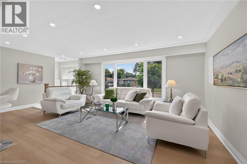 Wood-finish flooring with recessed lighting - 40 Purdy Crescent, Hamilton, ON - Indoor Photo Showing Living Room