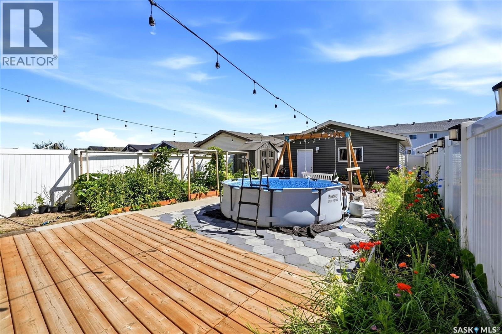 3409 Green Jade Lane, Regina, SK - Outdoor With Above Ground Pool With Deck Patio Veranda