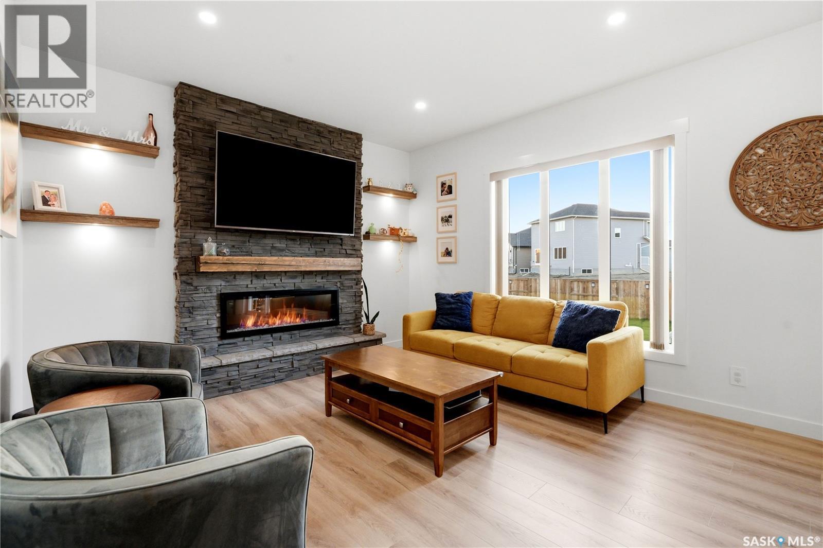 302 Chelsom Manor, Saskatoon, SK - Indoor Photo Showing Living Room With Fireplace
