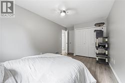 Recessed ceiling fan, wood-finish flooring, light gray wall tones, and white bi-fold closet doors -