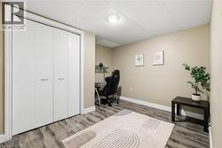 Wood-finish flooring, drop ceiling, recessed lighting, and a bi-fold closet -