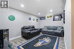 Recessed lighting, wood-finish flooring, drop ceiling, and light gray walls -