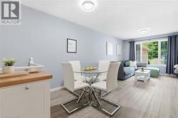 Light-toned wood-finish flooring throughout, bright walls, and recessed lighting -