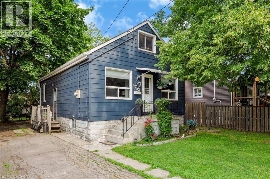 Blue siding exterior with white trim, a gabled roof, and multiple windows - 703 Brighton Avenue, Hamilton, ON - Outdoor