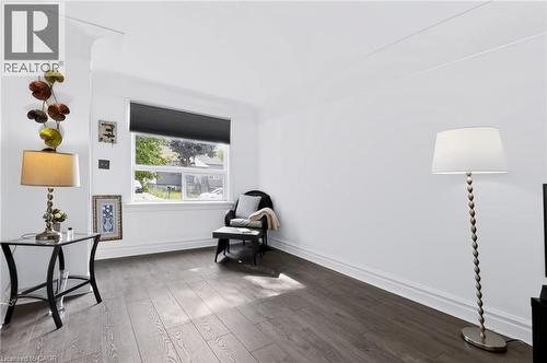 Wood-finish flooring, white walls, and a window with a pleated shade - 703 Brighton Avenue, Hamilton, ON 