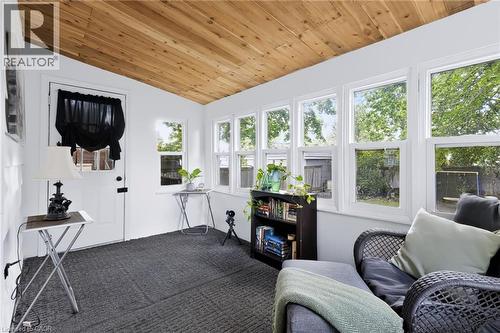 Wood-finish sloped ceiling, white paneled walls, and multiple windows - 703 Brighton Avenue, Hamilton, ON 