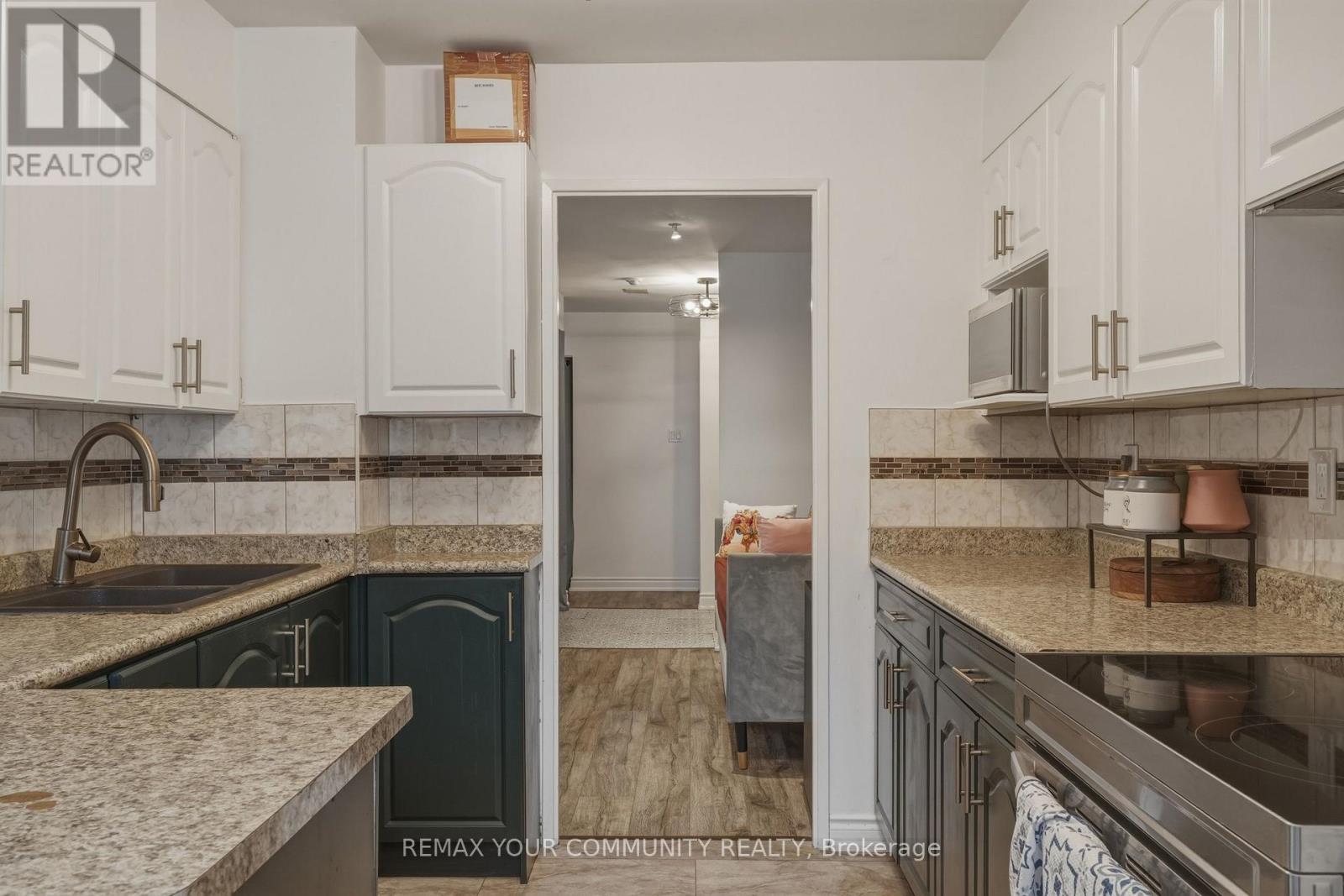103 - 410 Mclevin Avenue, Toronto, ON - Indoor Photo Showing Kitchen With Double Sink