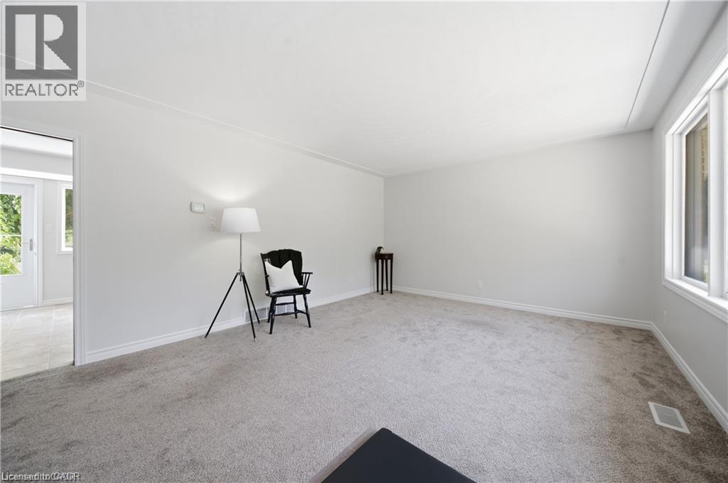 Light gray carpeting with white trim, white walls, and a white ceiling - 64 Warren Road, Kitchener, ON - Indoor Photo Showing Other Room
