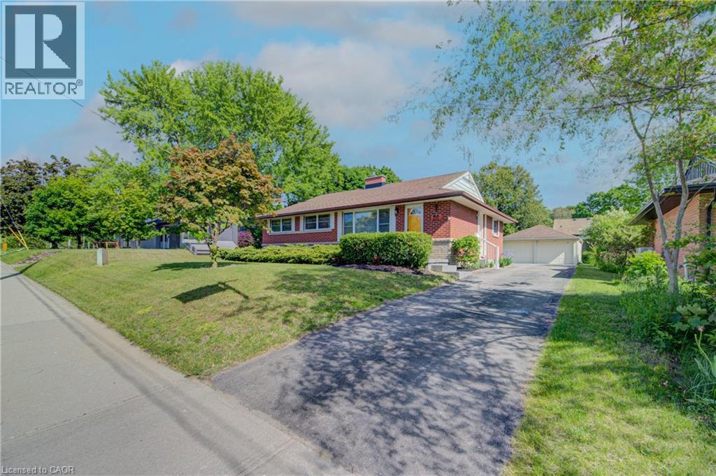 Red brick exterior with white trim, a gabled roof, and an attached two-car garage - 251 Union Street E, Waterloo, ON - Outdoor