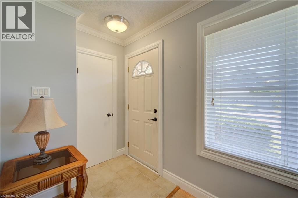 Light-toned tile flooring, light gray walls, white door with arched transom, and a large window with blinds - 251 Union Street E, Waterloo, ON - Indoor Photo Showing Other Room