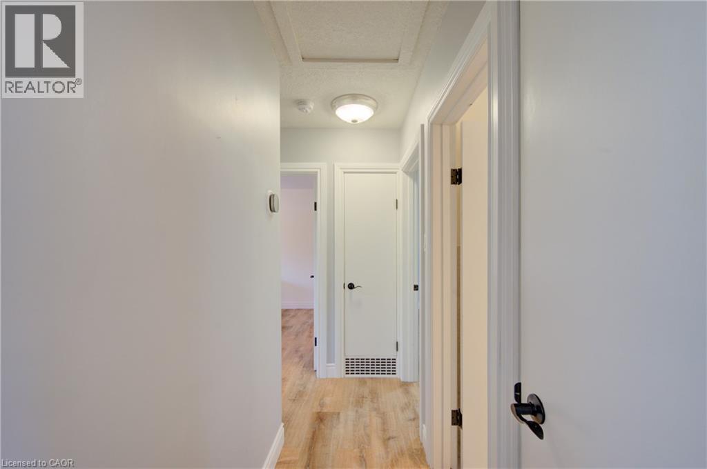 Hallway featuring wood-finish flooring, white walls, and white trim - 251 Union Street E, Waterloo, ON - Indoor Photo Showing Other Room