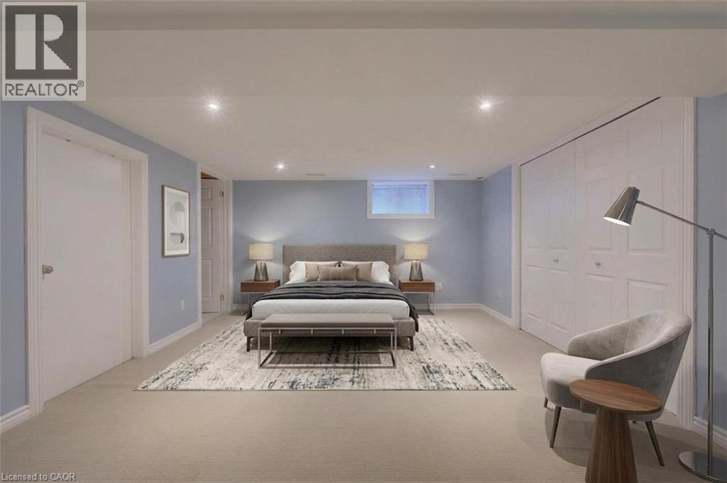Recessed lighting throughout, light blue wall paint, white trim, window, and bi-fold closet doors - 251 Union Street E, Waterloo, ON - Indoor Photo Showing Bedroom