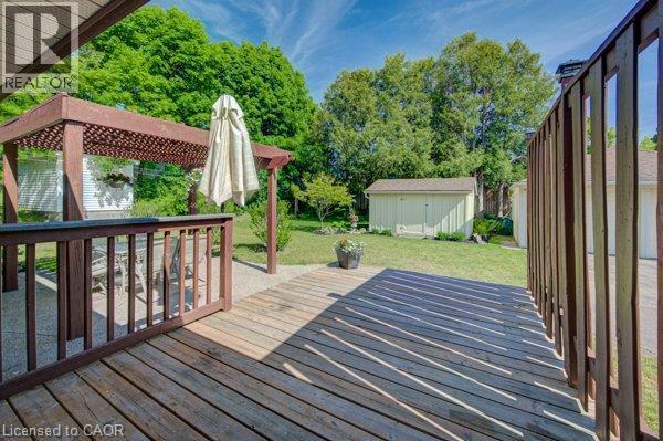 Wood-finish deck with railing, pergola, and gravel patio area - 251 Union Street E, Waterloo, ON - Outdoor With Exterior