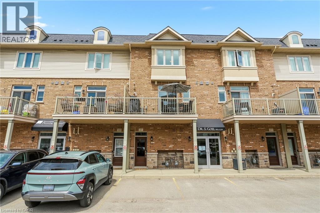 Brick and siding facade with multiple balconies and dormer windows - 4171 Palermo Common, Burlington, ON - Outdoor With Facade