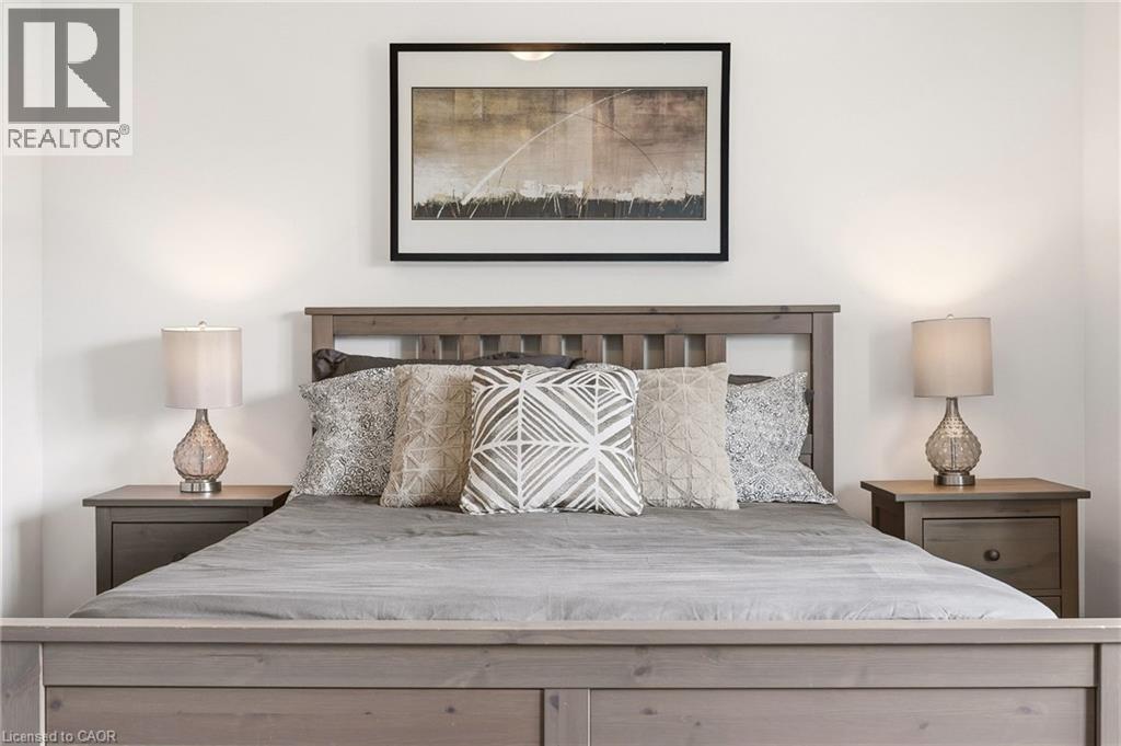 Gray-toned wood bed frame with slatted headboard - 4171 Palermo Common, Burlington, ON - Indoor Photo Showing Bedroom