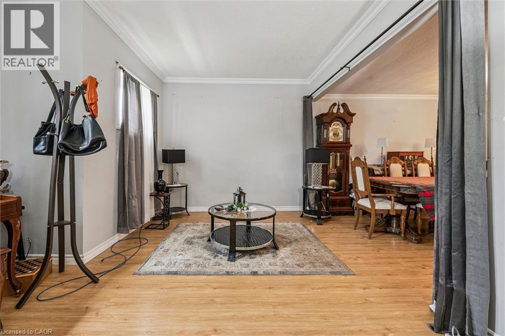 Wood-finish flooring throughout, with white crown molding and light gray wall paint - 27 Roseview Avenue, Cambridge, ON - Indoor