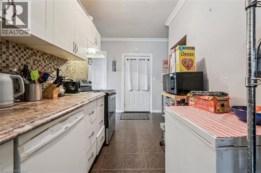 Full kitchen featuring white cabinetry, a mosaic tile backsplash, and a built-in dishwasher - 27 Roseview Avenue, Cambridge, ON - Indoor Photo Showing Kitchen