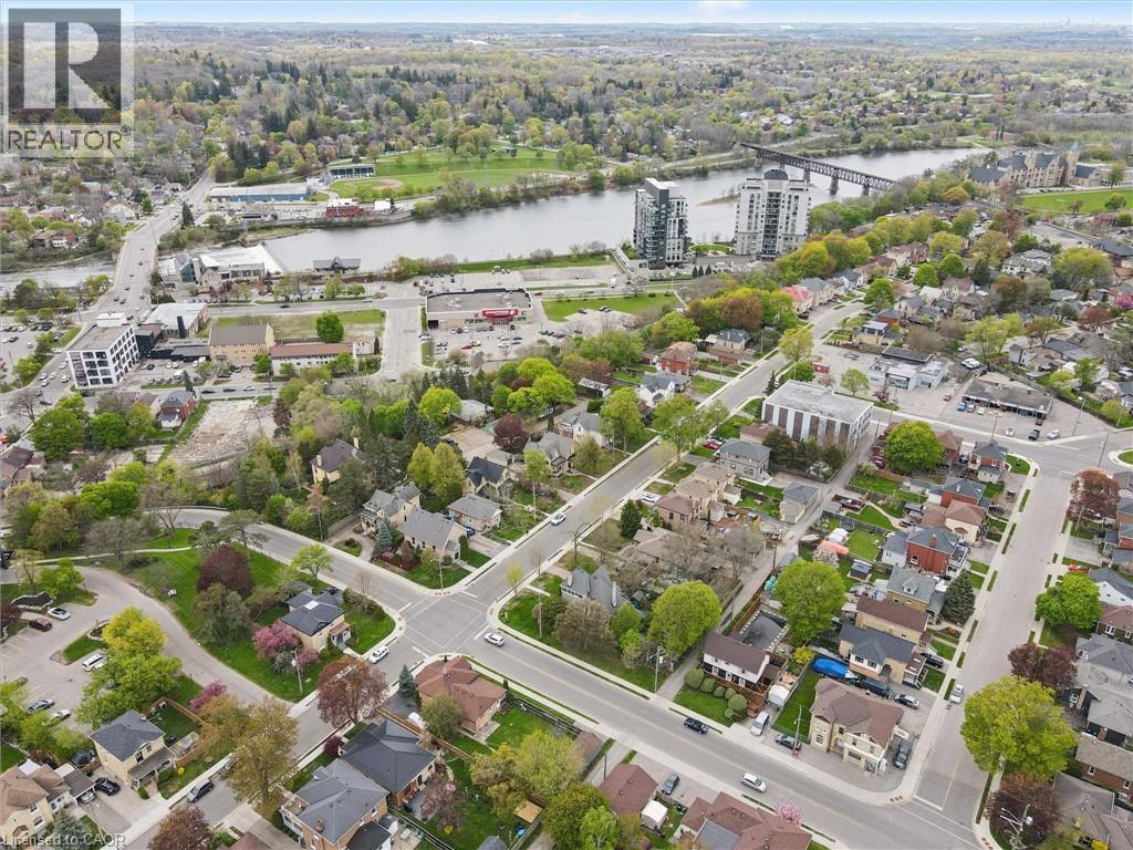 Aerial perspective showcasing a developed neighborhood with mature trees, established residential properties, and paved streets - 27 Roseview Avenue, Cambridge, ON - Outdoor With View