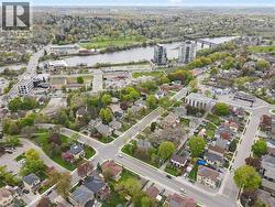 Aerial perspective showcasing a developed neighborhood with mature trees, established residential properties, and paved streets -