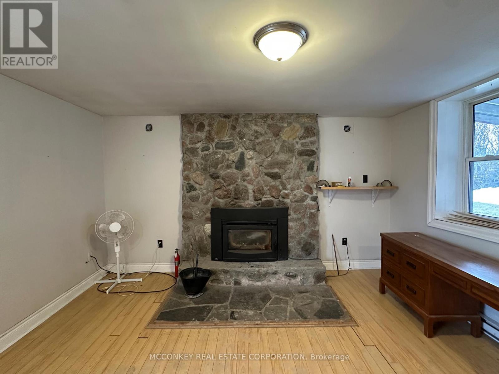 1702 Bensfort Road, Otonabee-South Monaghan, ON - Indoor Photo Showing Living Room With Fireplace