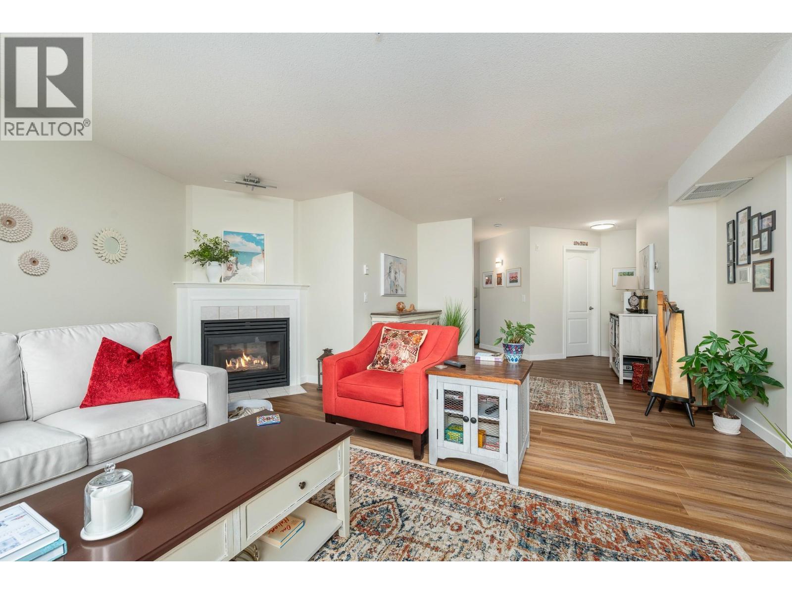 3301 Centennial Drive Unit# 309, Vernon, BC - Indoor Photo Showing Living Room With Fireplace