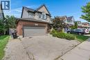 Brick and siding exterior with an attached garage and a paved driveway - 76 Renner Drive, Cambridge, ON  - Outdoor With Facade 
