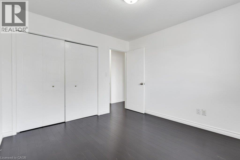 Dark wood-finish flooring - 76 Renner Drive, Cambridge, ON - Indoor Photo Showing Other Room